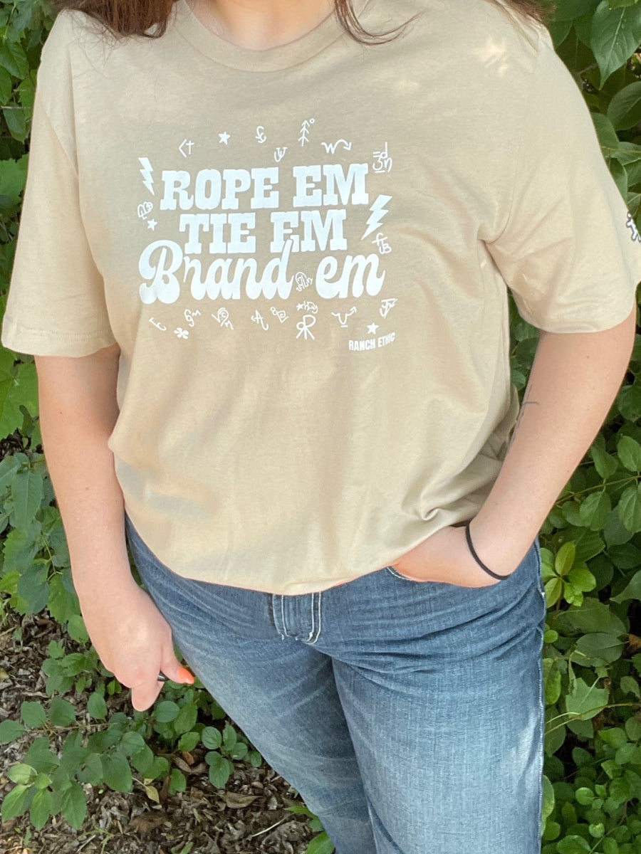 “Rope ‘Em. Tie ‘Em. Brand ‘Em." Tee